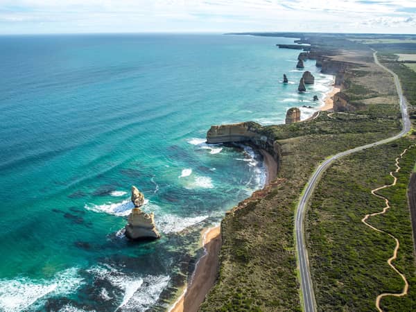 Aerial view of the Great Ocean Road winding along the clifftops above the Twelve Apostles
