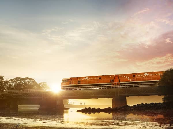 The Great Southern crossing the Boambee Creek bridge at sunset
