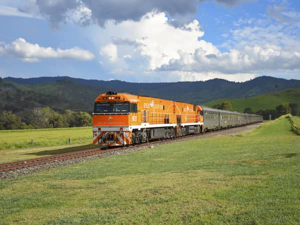 The orange Great Southern locomotive in green hills at Glenapp, Queensland