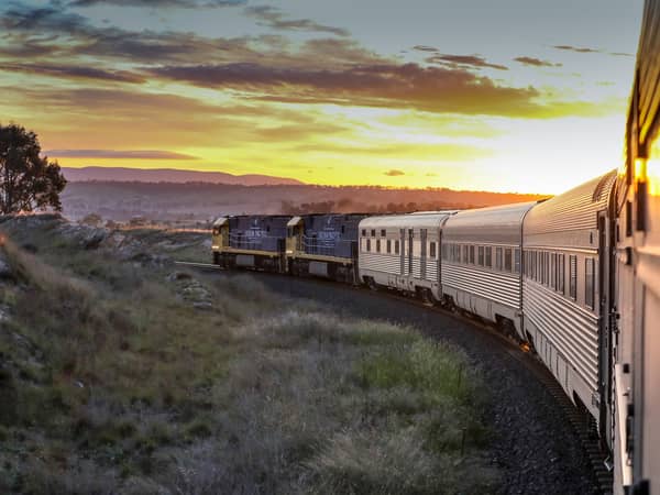 The Indian Pacific's carriages curving through hills at sunset