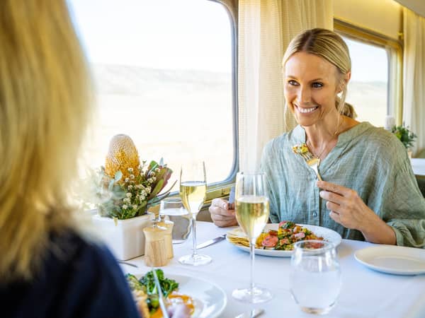 A guest enjoying lunch in the Ghan's dining carriage
