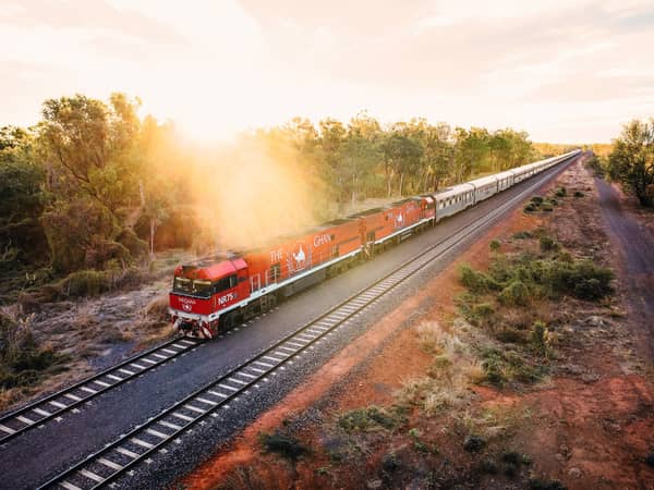 The Ghan travelling through woodland near Katherine at sunrise